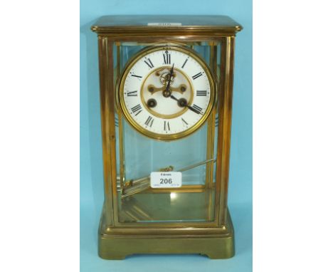 A Victorian brass four-glass mantel clock, the rectangular moulded case raised on bracket plinth, the French drum gong-striki