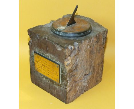 A block of oak with applied brass sun dial and compass, also a brass plaque inscribed 'This piece of oak is a relic of the Ol