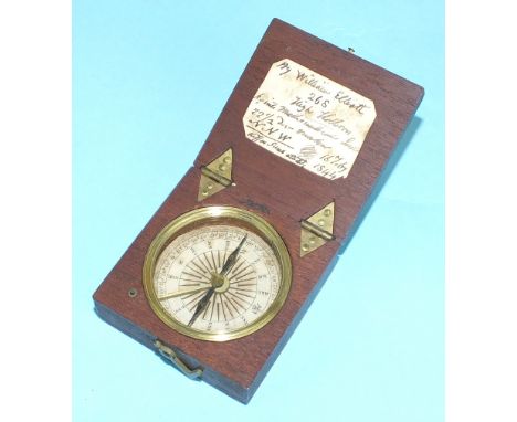 A mid-19th century mahogany cased compass with paper dial, blued needle with brake, the hinged lid with hand written paper la