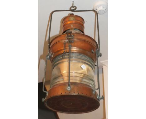 A copper ships fixed light of circular form with burner and metal hanger by R C Murray & Co, Glasgow, marked on brass plaque 