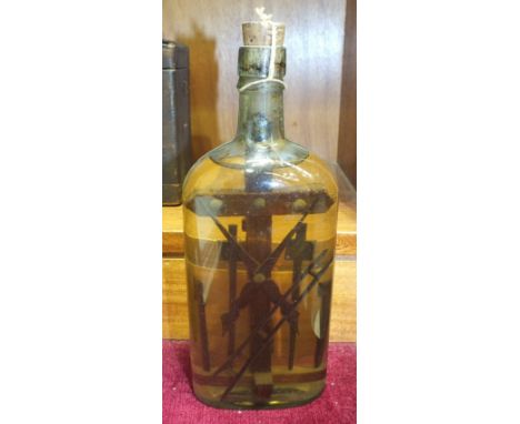 A Folk Art devotional bottle containing carved tools and a cross, preserved in liquid, 24cm high and three other examples, (4