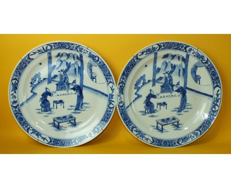 A pair of 19th century Chinese blue and white dishes decorated with figures playing Go, six-character Kang Hsi mark within do