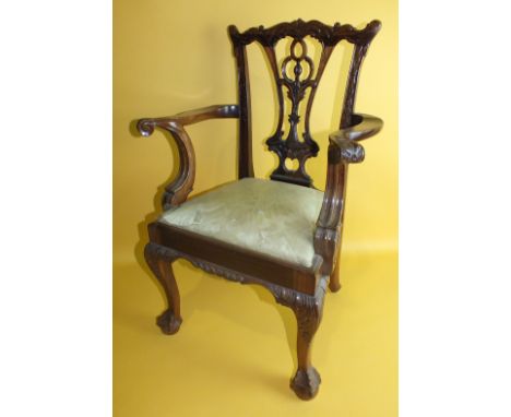 A reproduction Chippendale-style child's chair with drop-in seat, on carved cabriole legs, 66cm high.