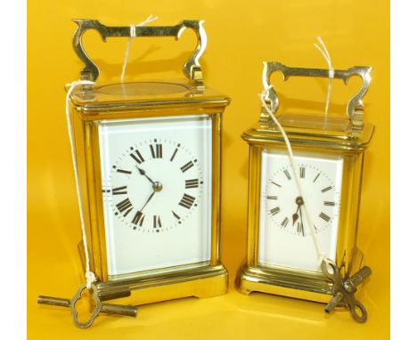 A French brass carriage timepiece with white enamel dial, 18cm high and a similar, smaller carriage clock, 15cm high, (table 