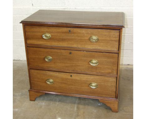 A Georgian mahogany rectangular chest of three long cockbeaded drawers, on bracket feet, 88cm wide, 86cm high.