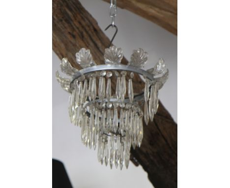 A centre light hung three tiers of concentric spear point drops and similar light fitting