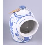 An Aldermaston salt pig with blue floral decoration, 7" high