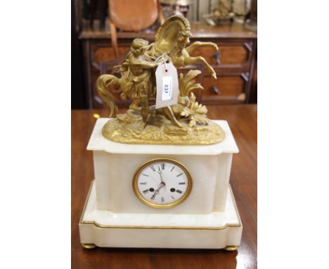 A 19th century white marble mantel clock with gilt metal surmount cast as a Grecian man and rearing horse and a cream table l