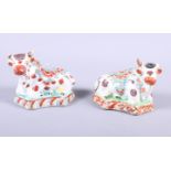 A pair of Delft floral decorated models of cattle, 4" long (damages)