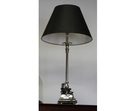 A silvered metal table lamp, on square base with black shade