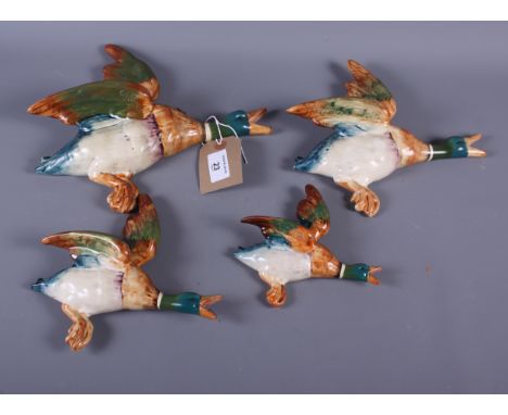 A set of four Beswick flying duck wall pockets (largest repaired)