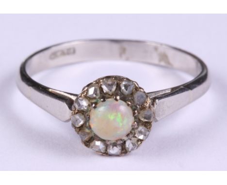 A platinum, opal and diamond cluster ring, size R, 3.7g