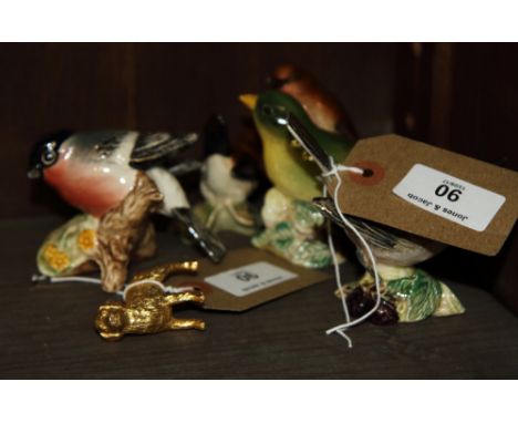 Five Beswick china models of birds, a folding brass cup, in leather case, and a miniature gold plated metal model of a golden