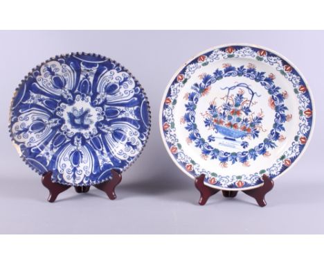 An 18th century Delftware shallow dish with Imari style decoration, 13 1/2" dia (restored), and a 19th century blue and white