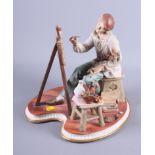 A Continental porcelain figure of an artist seated at his easel