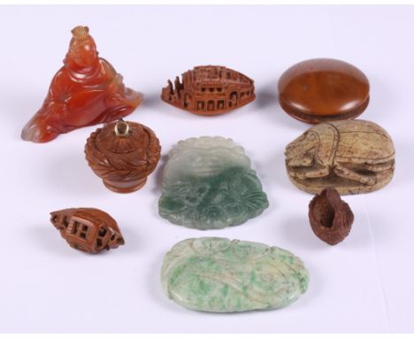 A carved jade tablet, another similar, two carved nut boats, a hardstone seated figure and other items