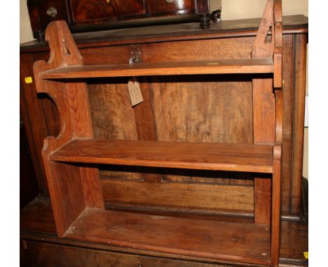 A pine three-tier wall shelf, 23" wide, and a three-tier book trough
