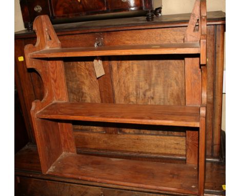 A pine three-tier wall shelf, 23" wide, and a three-tier book trough