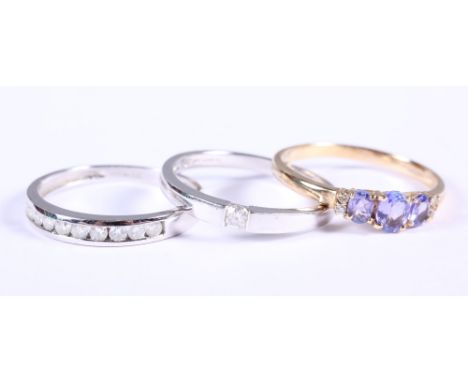 A 9ct white gold and diamond single stone ring, size R, a 9ct white gold ring set nine diamonds, size R, and a 9ct gold dress