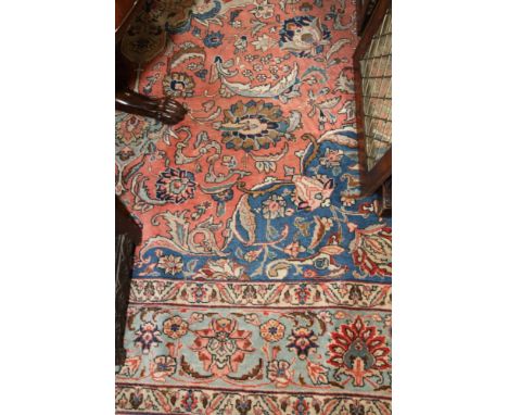 A Tabriz carpet decorated central blue floral medallion and spandrels on a red floral ground with three border stripes, 120" 