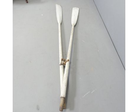 A pair of vintage painted oars. Length 213cm 