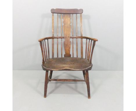 An antique elm farmhouse Windsor comb-back arm chair. Overall 63x100x55cm, seat 49x40x35cm.Good overall condition, some marks