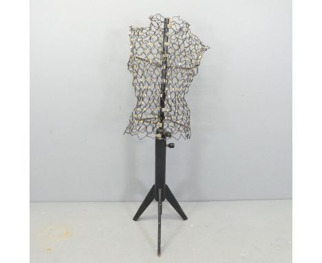 A mid-century French adjustable wire mannequin on ebonised tripod stand, labelled "Le Mannequin L'idéal, jardin Des modes".Re
