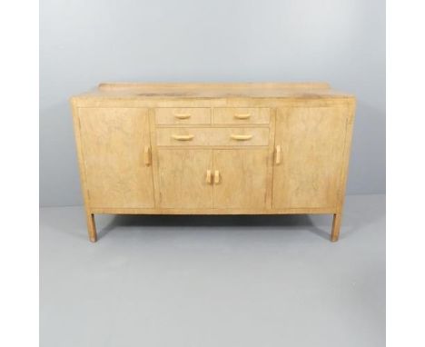 A 1930s Heals Art Deco sideboard in bleached walnut. 168x98x58cm.Overall well used condition. Surfaces are bleached and top s
