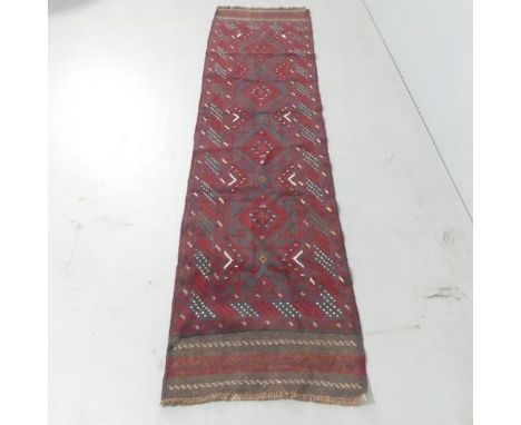 A red-ground Meshwani runner. 250x61cm. 