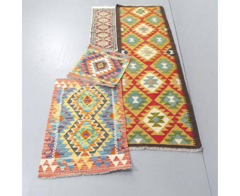 A kilim runner, 2 kilim mats and a small silk mat. 