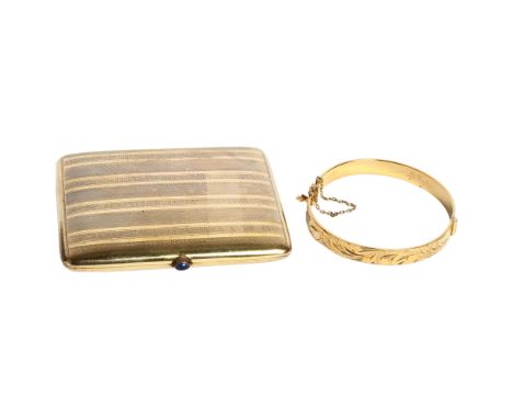 A gold plated cigarette case with a stone set button, and a gold plated engraved bangle 