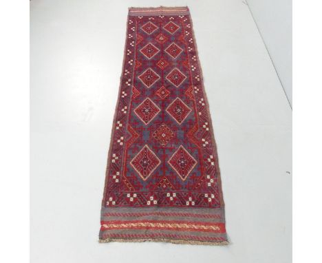 A red-ground Meshwani runner. 241x64cm. 