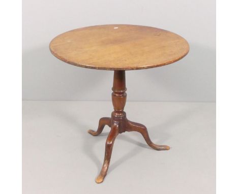 An antique oak circular tilt-top occasional table on mahogany tripod base. 70x68cm. 