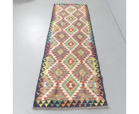 A Chobi Kilim runner. 243x80cm. 