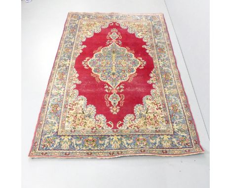 A red-ground Kerman carpet. 220x145cm. 