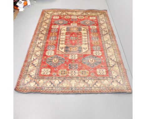 A red and cream-ground Kazak carpet. 235x177cm. 