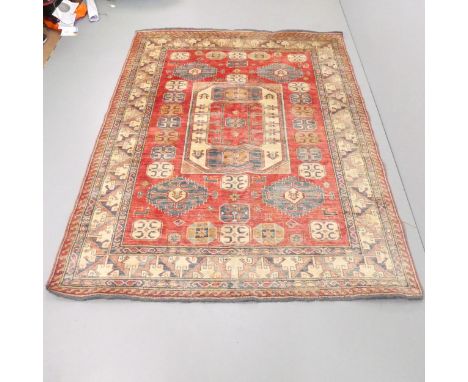 A red and cream-ground Kazak carpet. 235x177cm. 