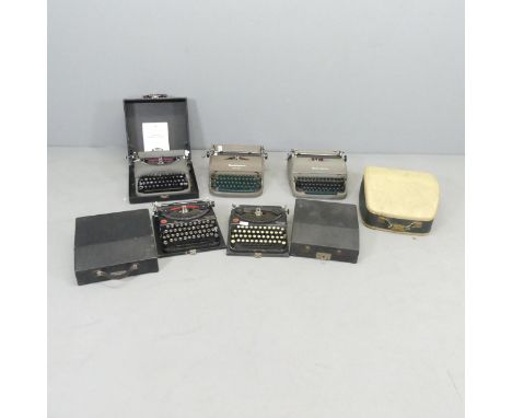 Five various Remmington typewriters, and another locked in case (unidentified). (6)Models include two Portables, two Quiet-Ri