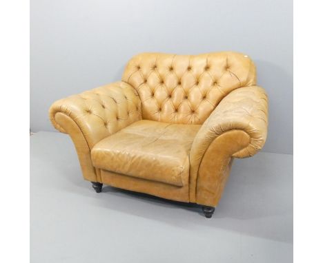 A button-back brown leather upholstered Chesterfield style arm chair. Overall 140x92x105cm, seat 60x43x69cm.Leather has dried