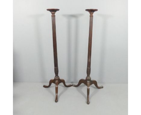 A pair of mahogany torchere stands on tripod bases. H - 150cm. 