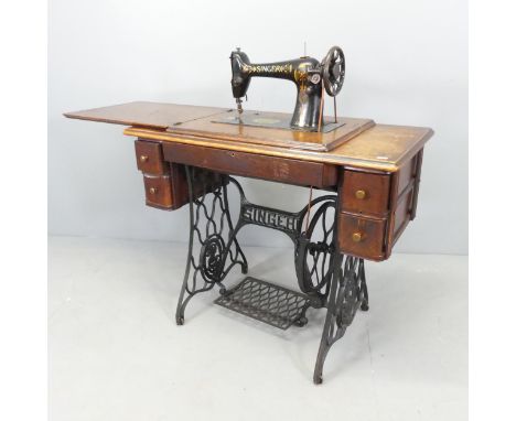 A vintage Singer treadle sewing machine. Dimensions (deployed) 128x102x46cm, stowed 92x78x46cm. 