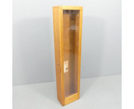 A mid-century teak hanging display cabinet with single glazed door, adapted from a clock case. 29x129x18cm. 