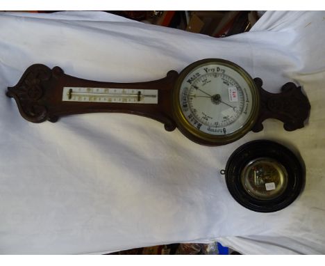 An Aneroid Barometer and Thermometer in a carved oak banjo pattern case and one other aneroid barometer in a circular case.