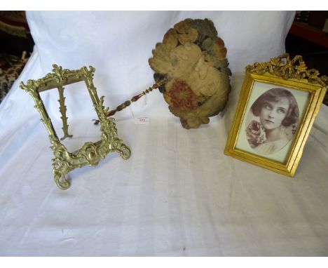 A gilt wood Table Photograph Frame with easel stand, a gilt metal Table Photograph Frame, and a painted face Fan with gilded 