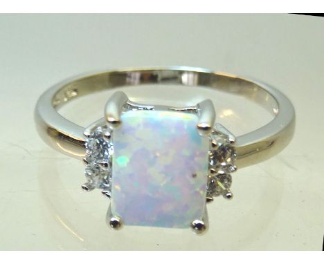 A silver Dress Ring set with square opal and cubic zirconia.