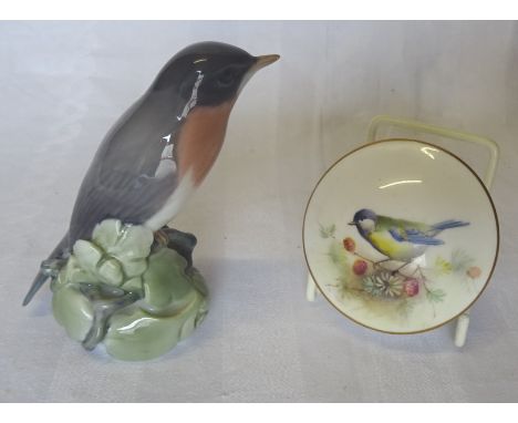 A Royal Copenhagen Figure of a perched Robin, No. 1516 and a Royal Worcester trinket box and cover painted with a blue tit.  