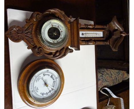 An Aneroid Barometer and Thermometer in carved oak case, and one other Aneroid Barometer in circular case.
