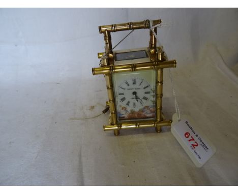 A small Carriage Timepiece, the enamel dial decorated with cherubs and in brass bamboo pattern case, with bevelled glass pane