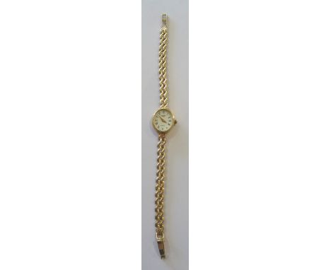 A ladies Rotary quartz Wristwatch with oval white dial, Roman numerals in a 9ct. gold case on a gold strap.  (11gms gross)