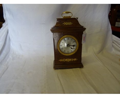 A reproduction Mantel Clock in a figured walnut caddy-top case with brass mounts, 9" (23cms) high.